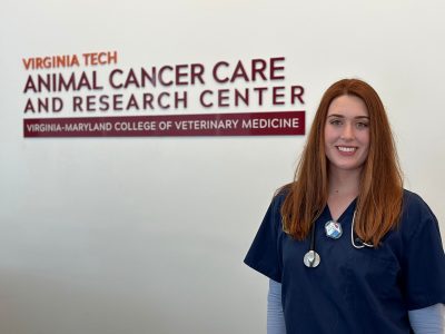 Photo of Michelle Lund in front of the ACCRC wall sign.