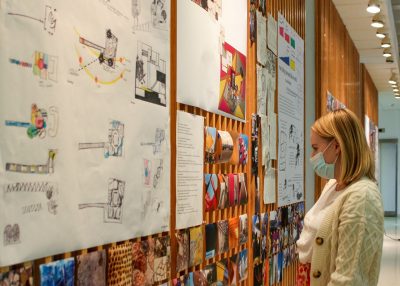School of Architecture + Design student observing exhibit in the lobby of Cowgill Hall from the summer 2021 CASA program.