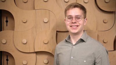 man in front of decorative wooden display